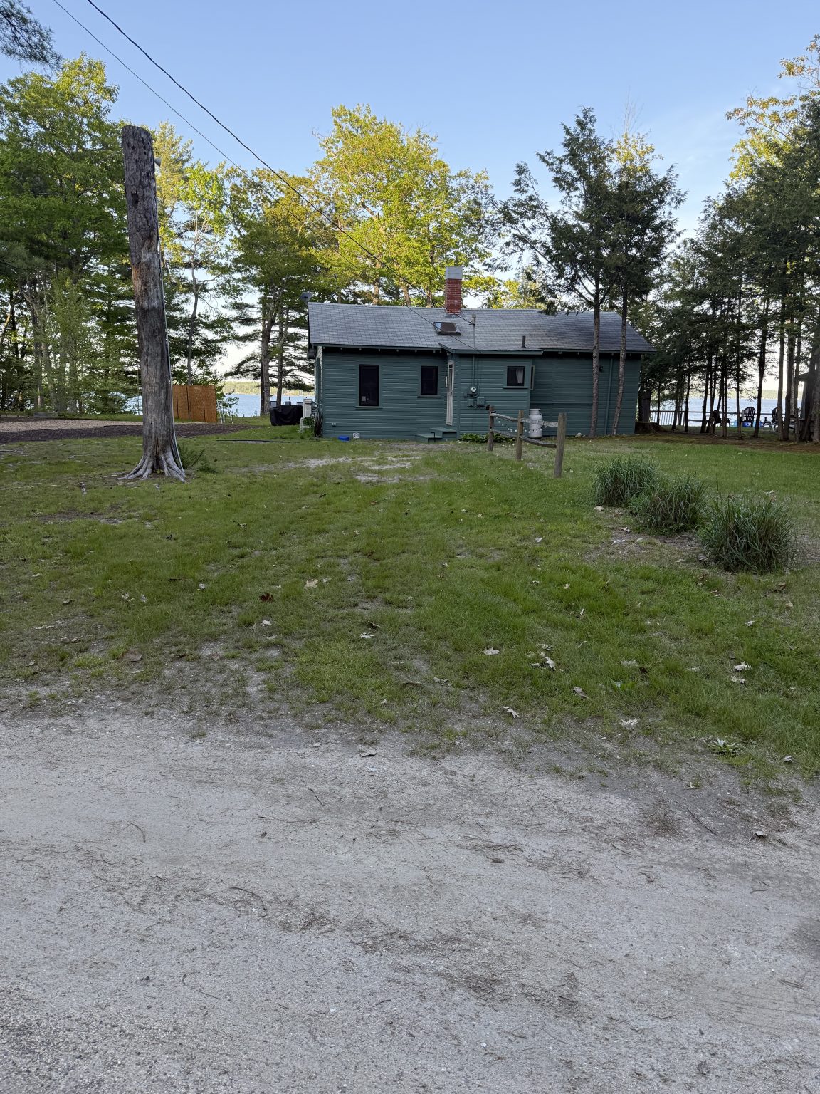 Exterior of the Sebago Retreat cottage viewed from the lawn near the beach